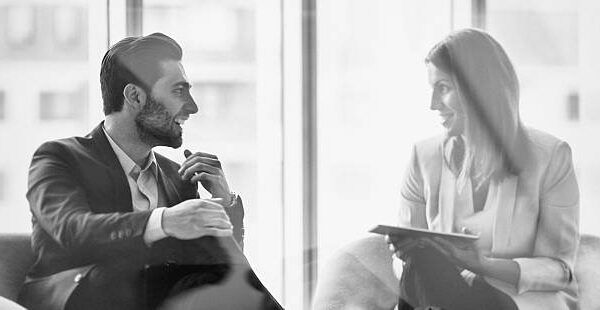 A businessman discussing with her colleague in the office building